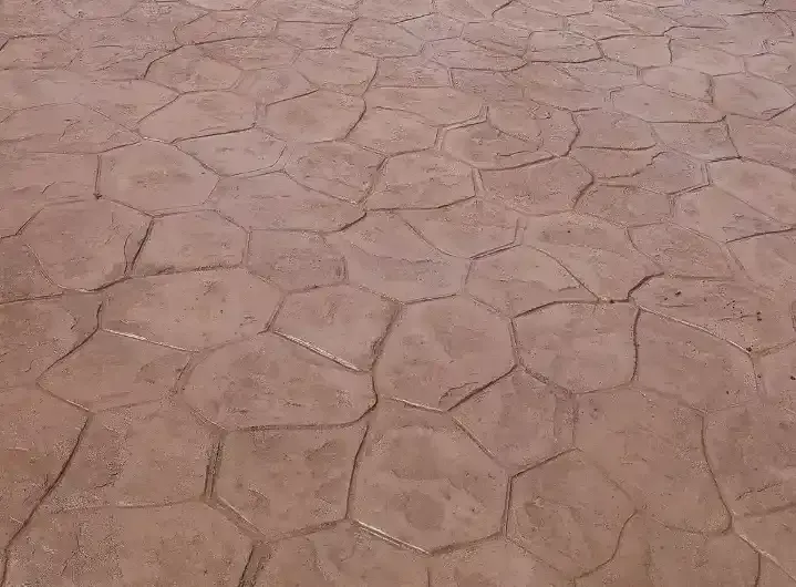 A close up of a brick floor with a hexagonal pattern.