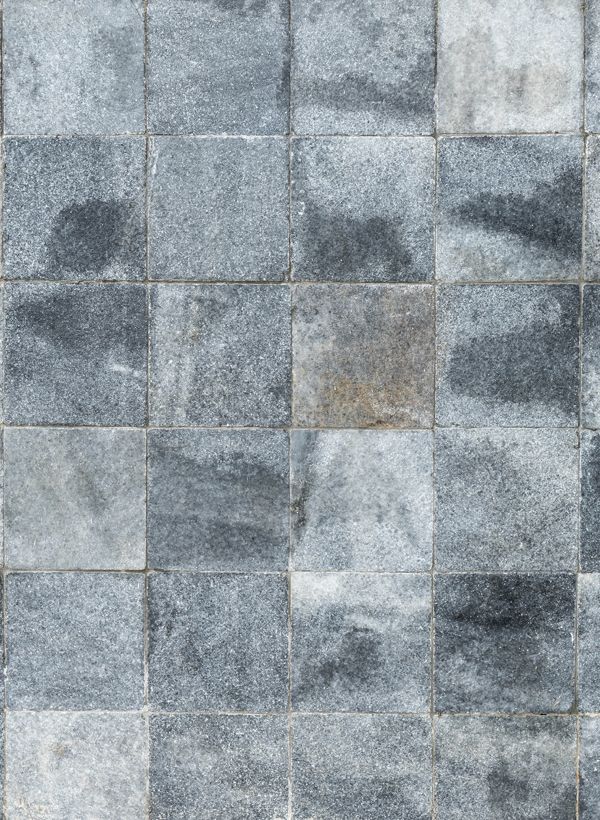 A close up of a gray marble stamped concrete floor.