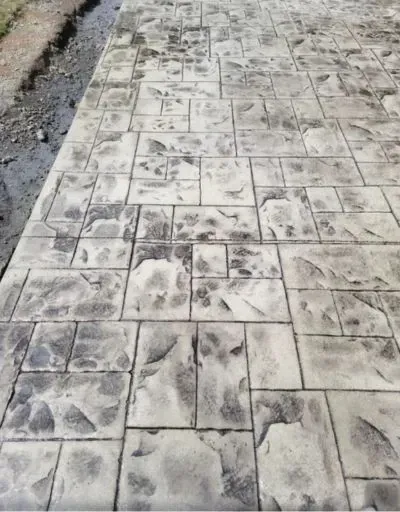 A close up of a concrete floor with a pattern on it.