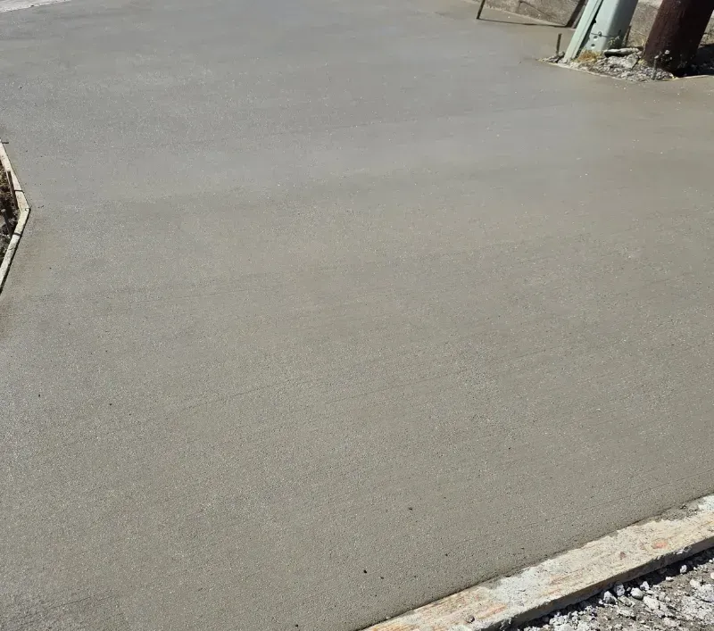 Freshly poured concrete driveway, light gray, with a smooth surface in Lynden WA.