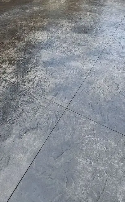 a close up of a stamped and stained concrete Driveway with a pattern on it in Bellingham Washington.