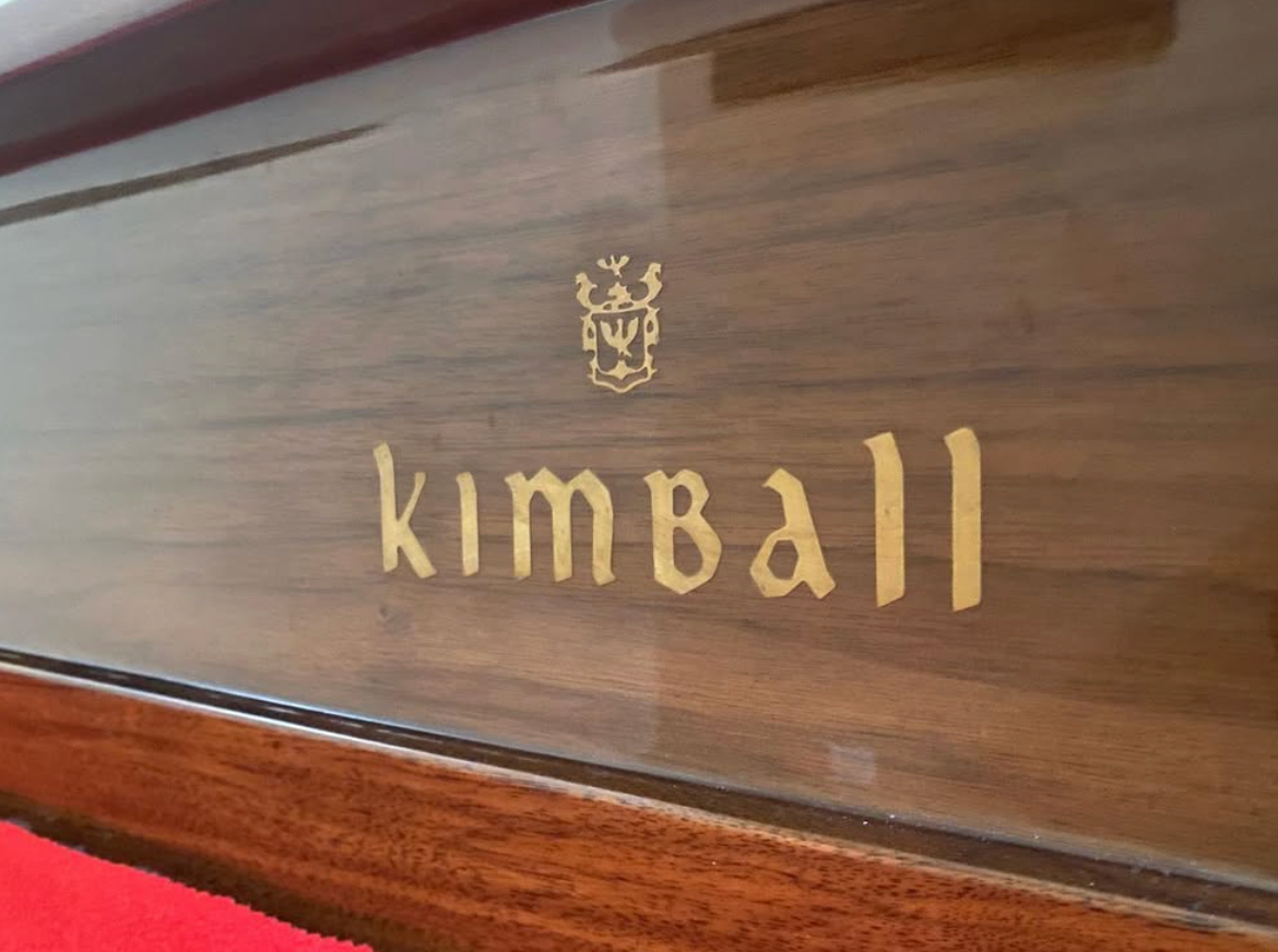 Wooden panel with gold “Kimball” lettering and logo