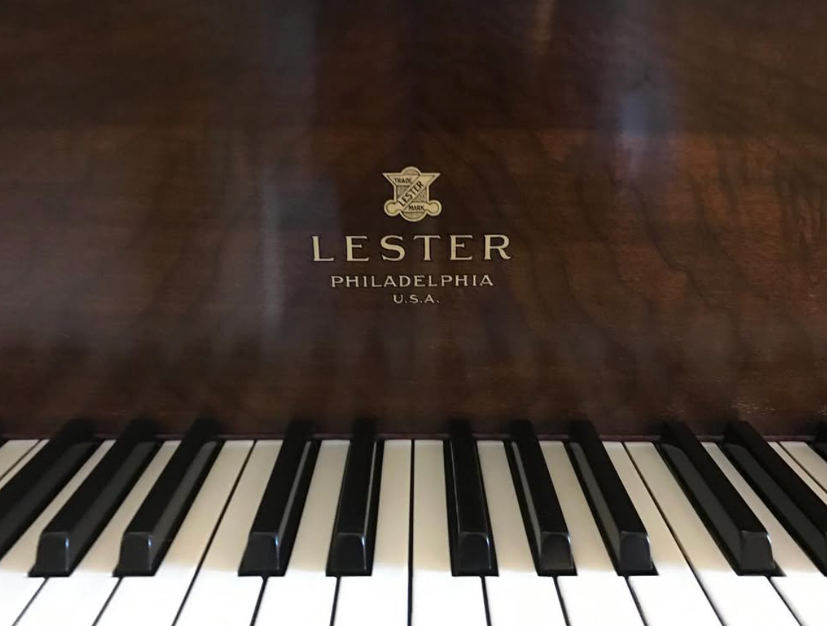 Close-up of a Lester Philadelphia piano keyboard with a dark wood finish