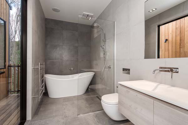 gray modern bathroom with lifted tub