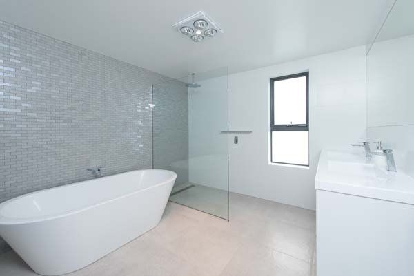 white bathroom with exposed tub