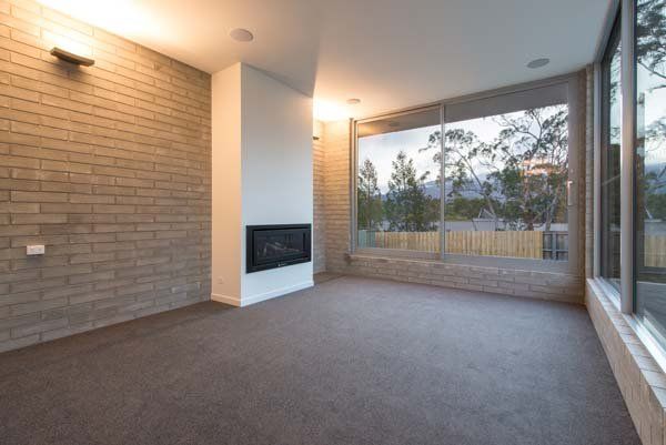 carpeted living area with fireplace
