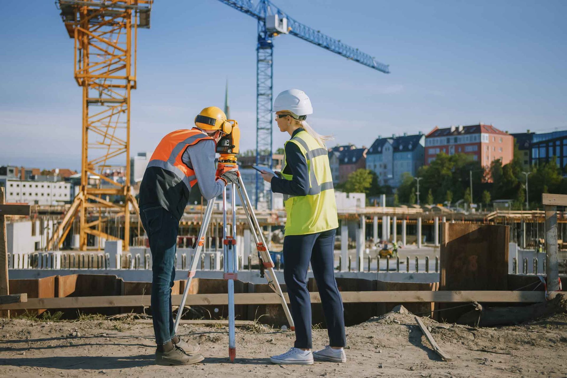 A man and a woman are working on a construction site.