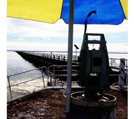 A blue and yellow umbrella is sitting next to a machine