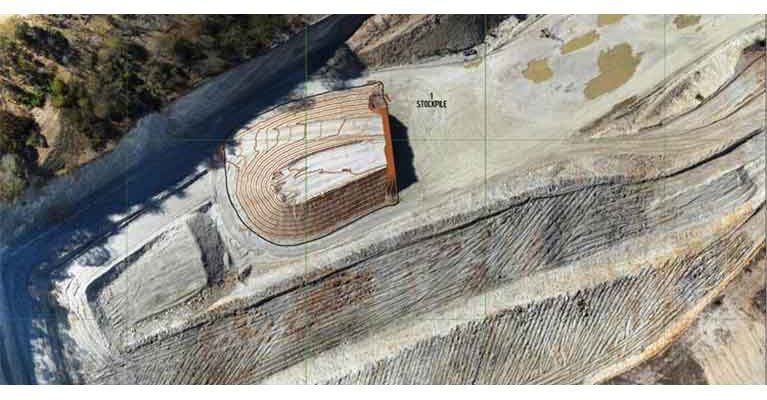 An aerial view of a large rocky area with a building in the middle of it.