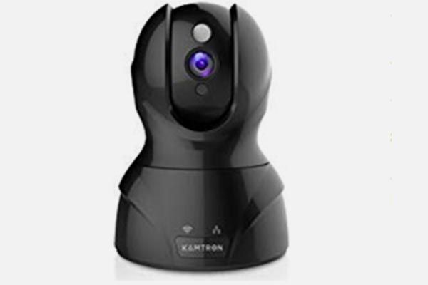 A black camera is sitting on a white surface