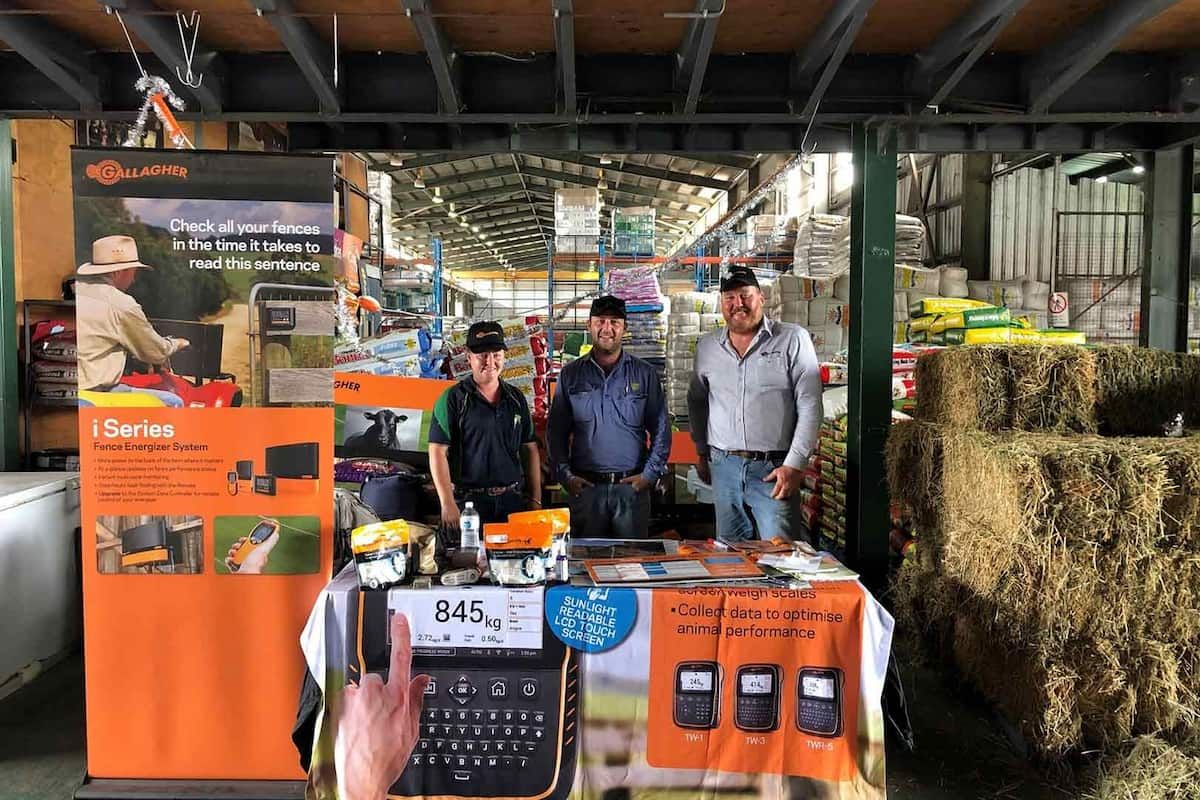 A Group Of Men Are Standing Around A Table In A Store — TGT Pty Ltd in Mareeba, QLD