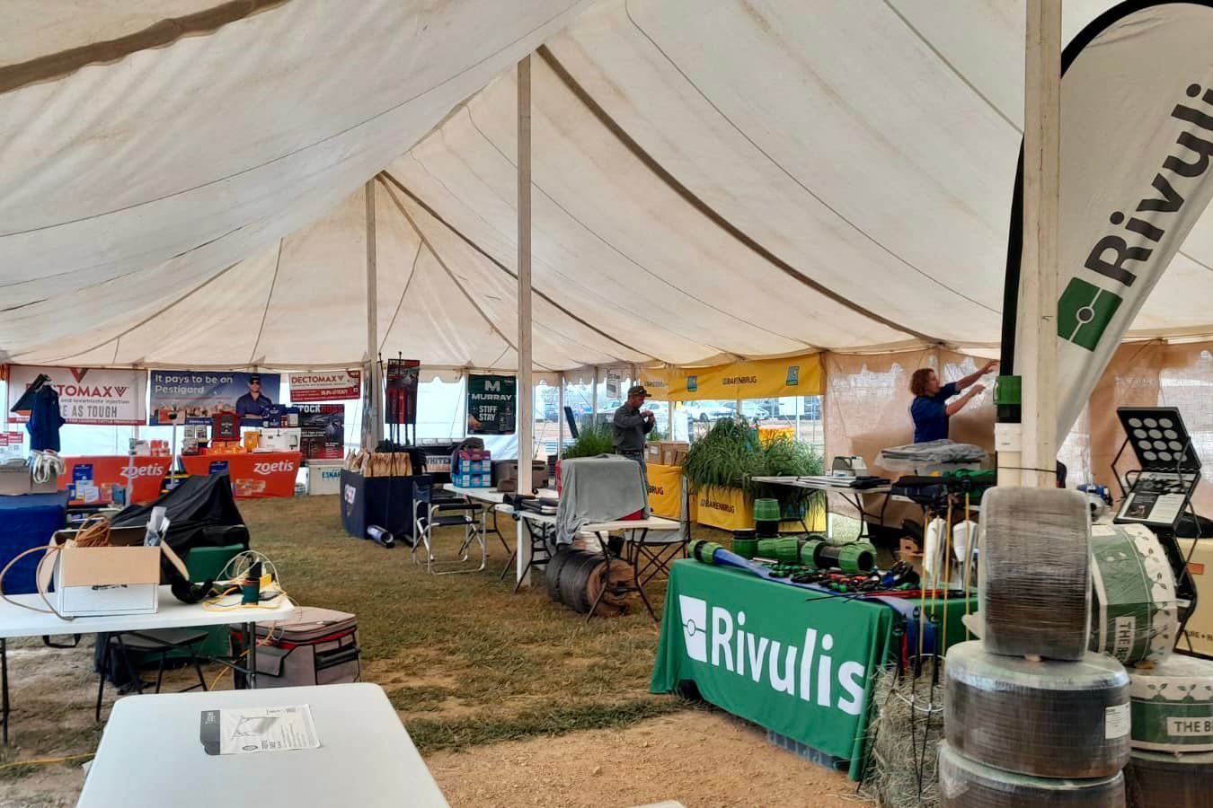 A Large Tent With Tables And A Green Sign That Says Rivulis — TGT Pty Ltd in Mareeba, QLD