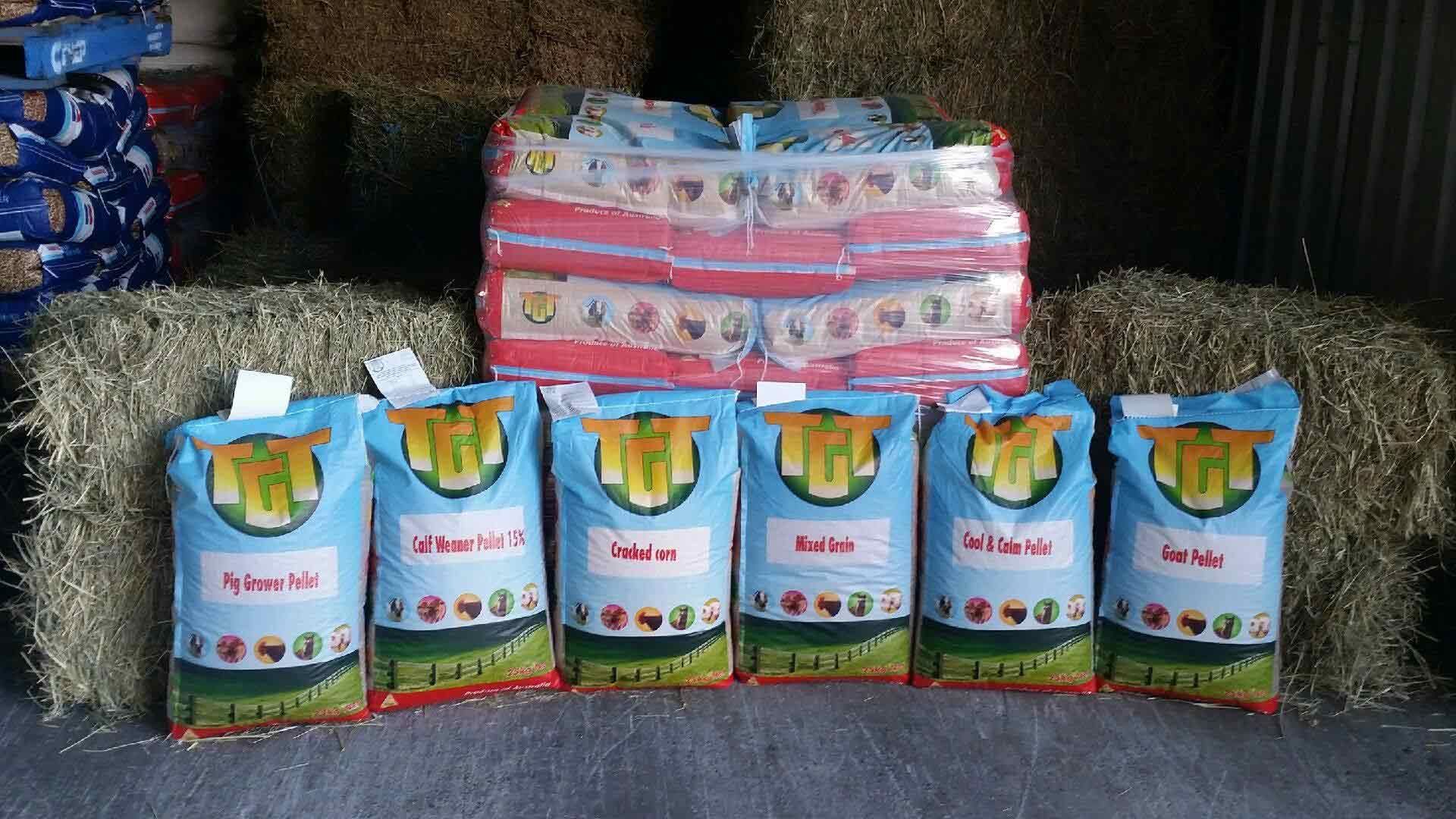 a Bunch of Bags of Hay Are Sitting on Top of Bales of Hay — TGT Pty Ltd in Mareeba, QLD