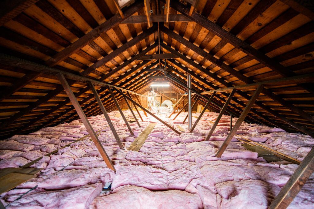 There is a lot of insulation in the attic of a house.