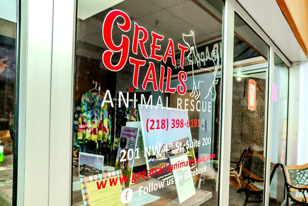 Great Tails Animal Rescue storefront with red signage and contact info.