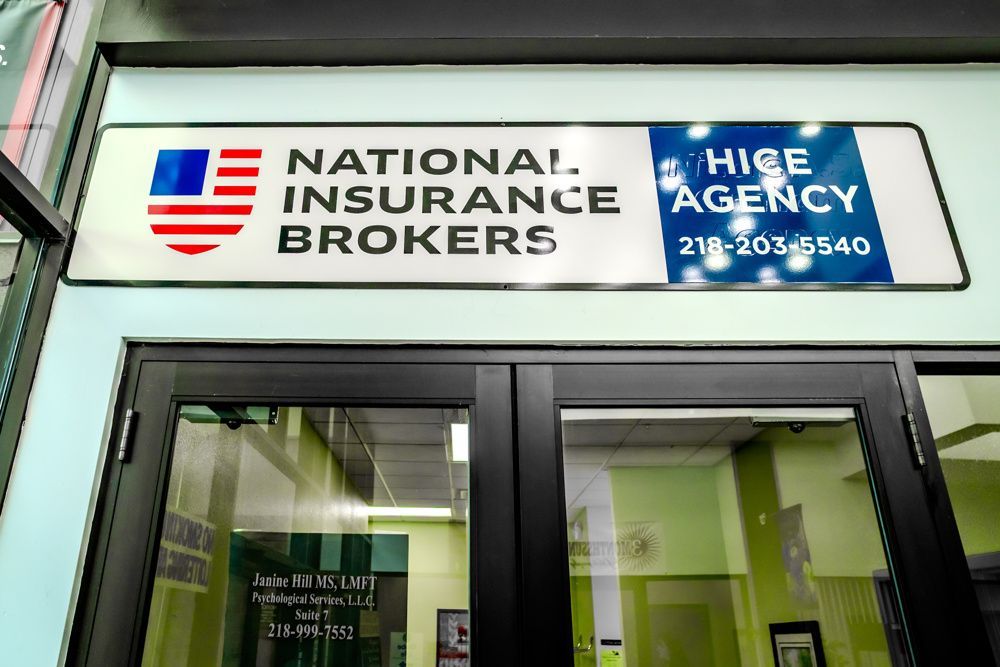 Sign for National Insurance Brokers with US flag, phone number.