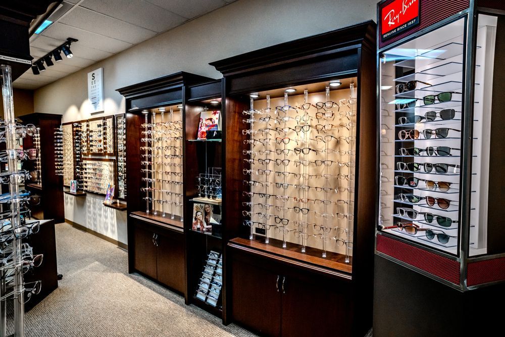 Eyeglass store interior with display cases showcasing various frames.