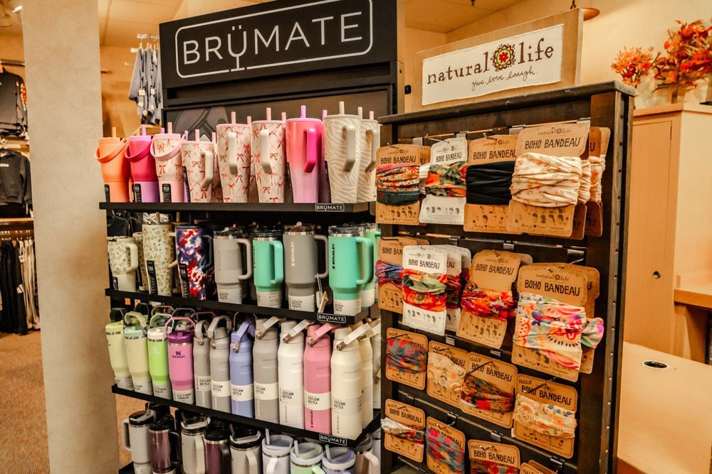 Display of water bottles and accessories for sale in a store; various colors and designs.