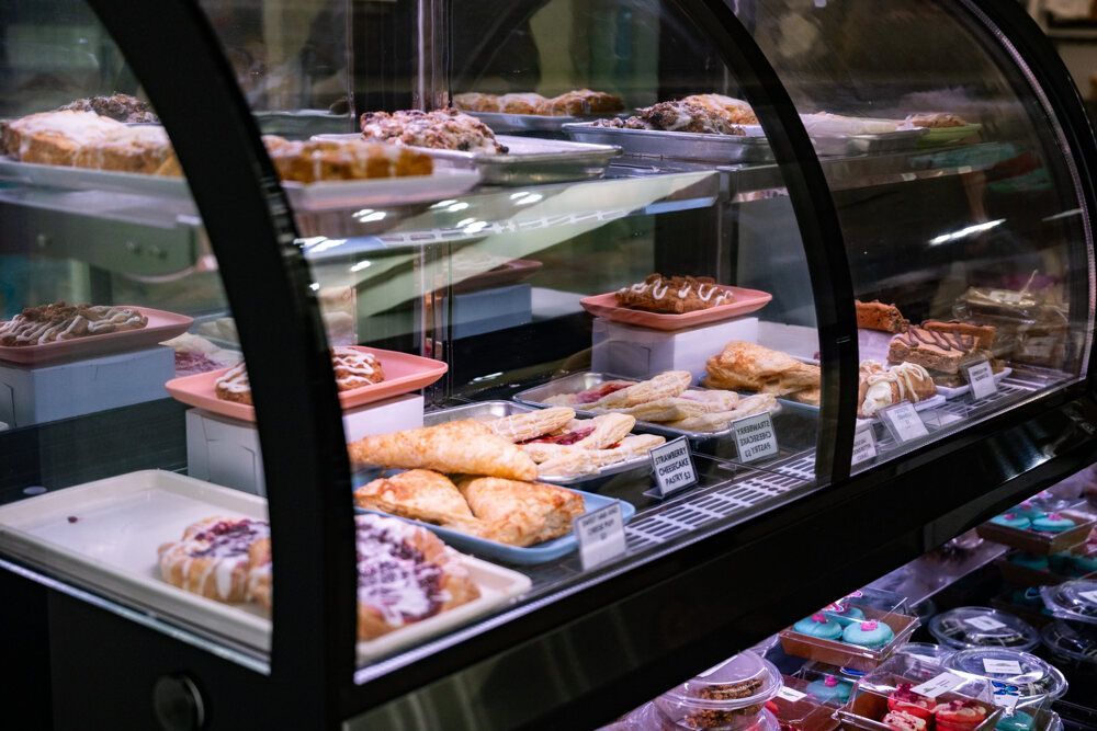 Pastries displayed inside a glass bakery case.