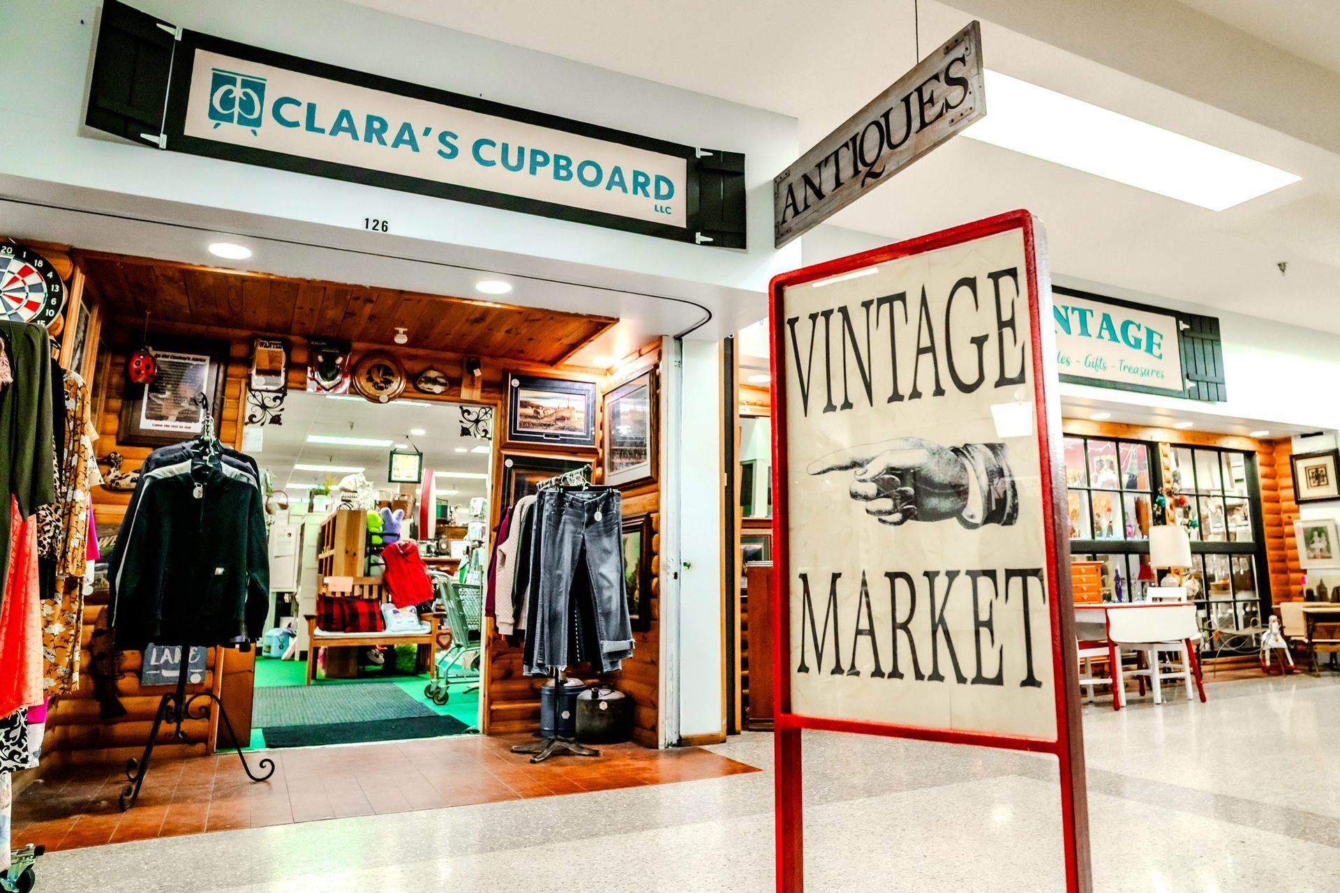 Exterior of Clara's Cupboard, a vintage market, with a sign reading 