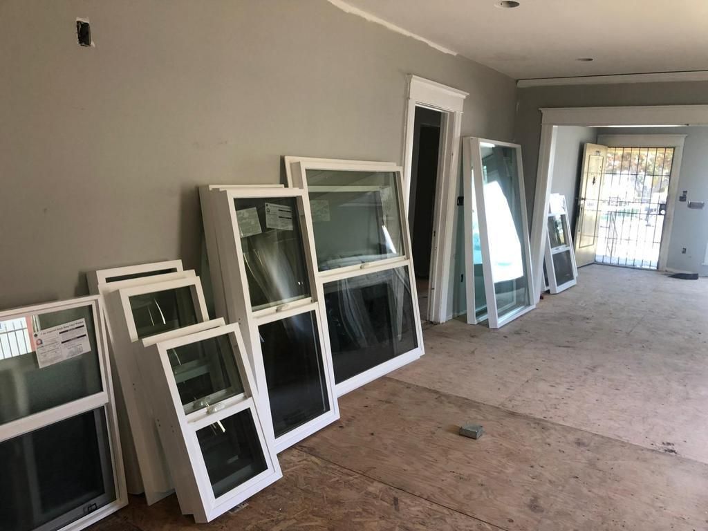 A room filled with lots of windows and mirrors.