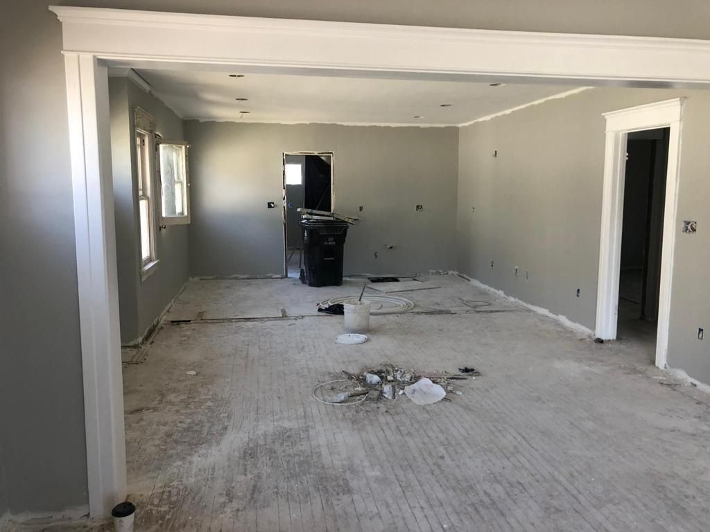 An empty room with gray walls and white trim