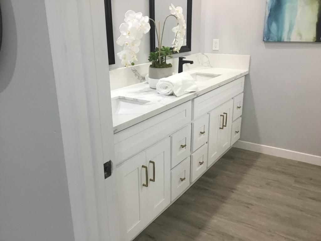 A bathroom with two sinks and two mirrors.