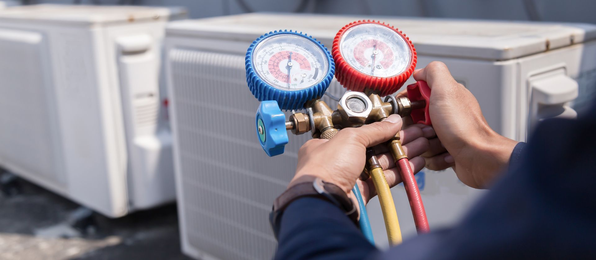 Technician using gauges to check the air conditioning system.
