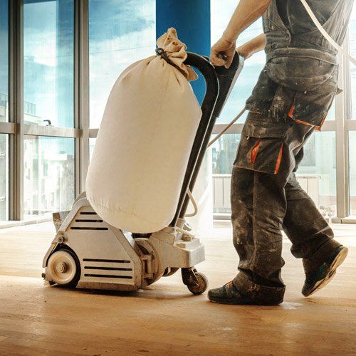 wood floor being sanded