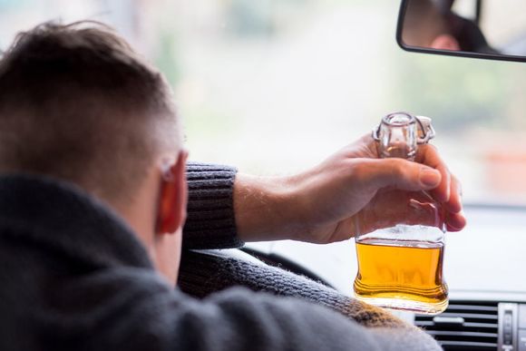 Man drinking alcohol and driving — Criminal Defense Lawyer in Piscataway, NJ