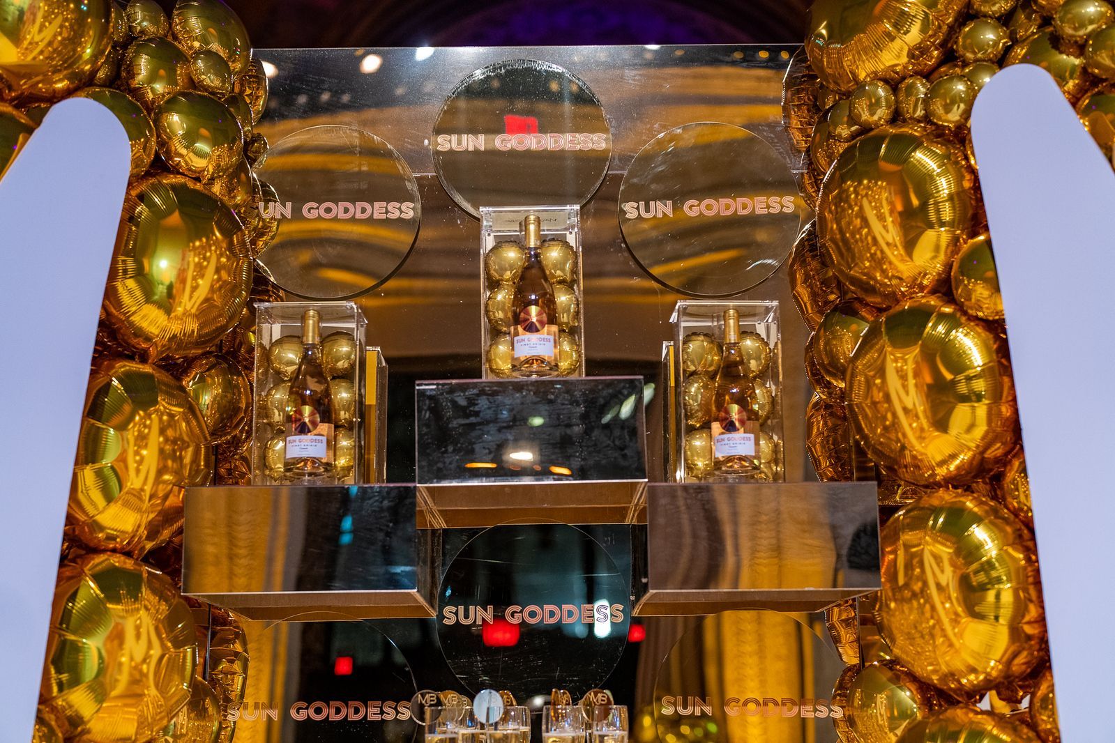 A display of gold balloons with the word goddess on it