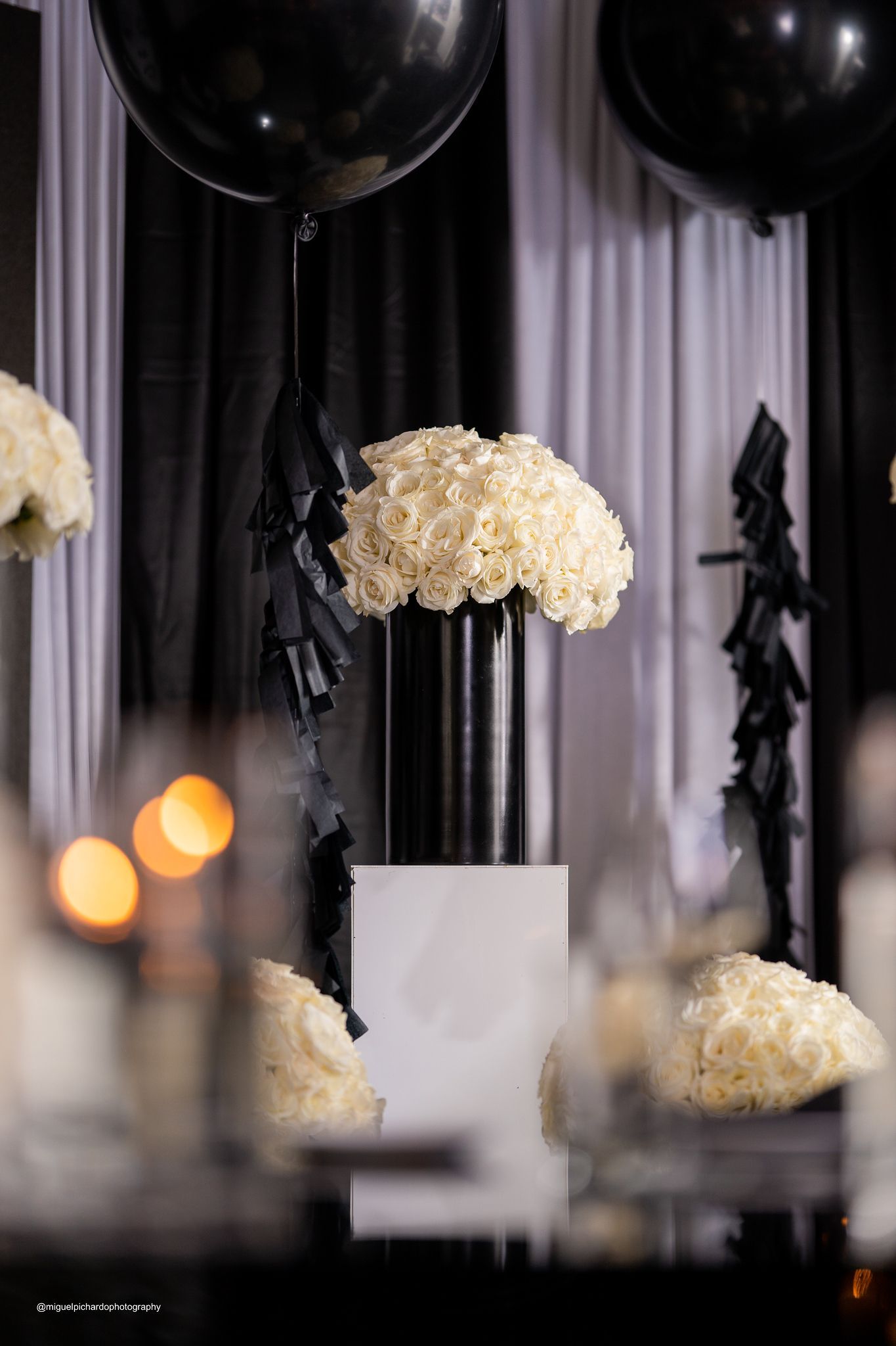 A bunch of gold balloons are sitting on the floor of a building.