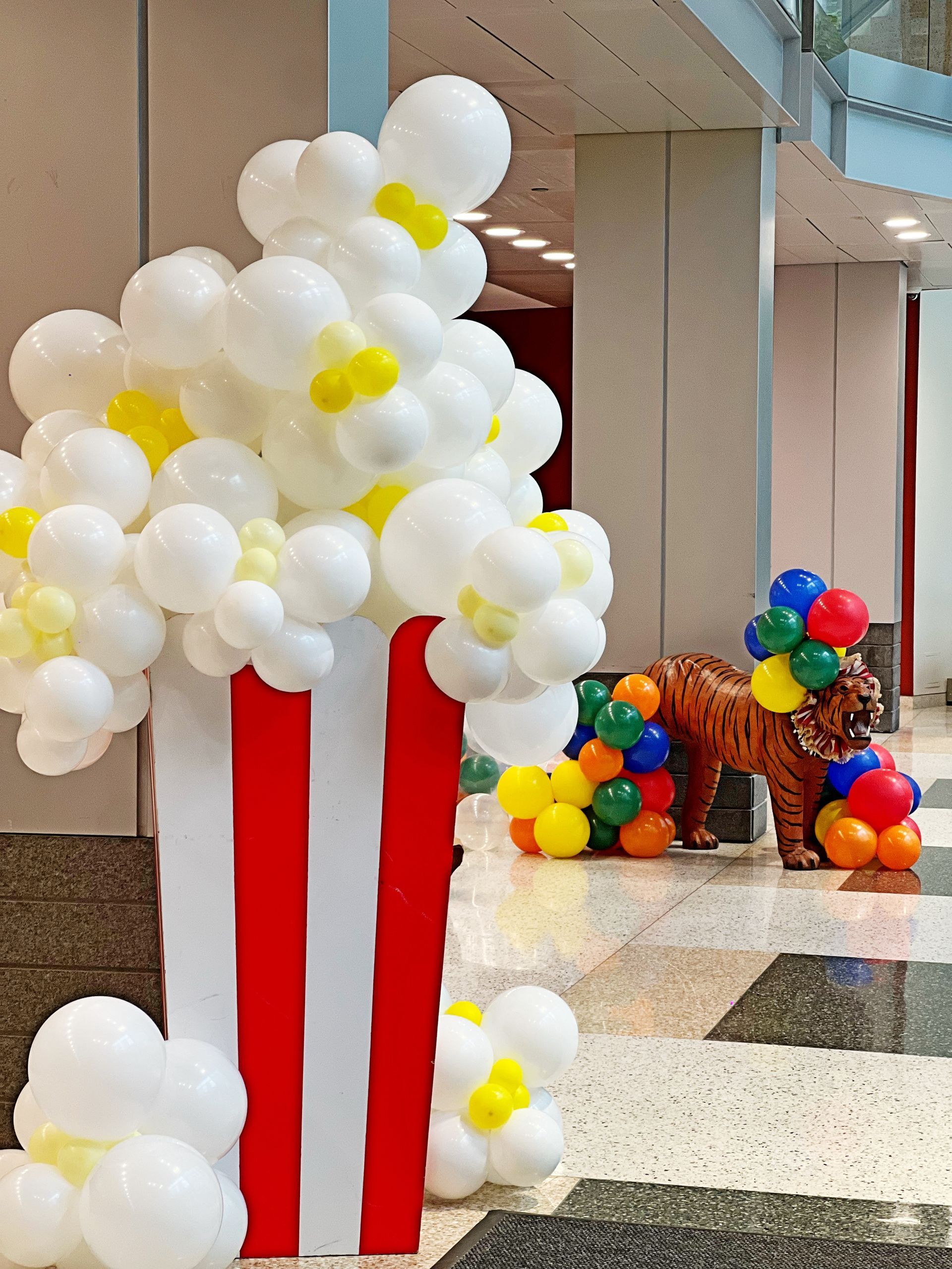 A popcorn box made out of balloons in a hallway