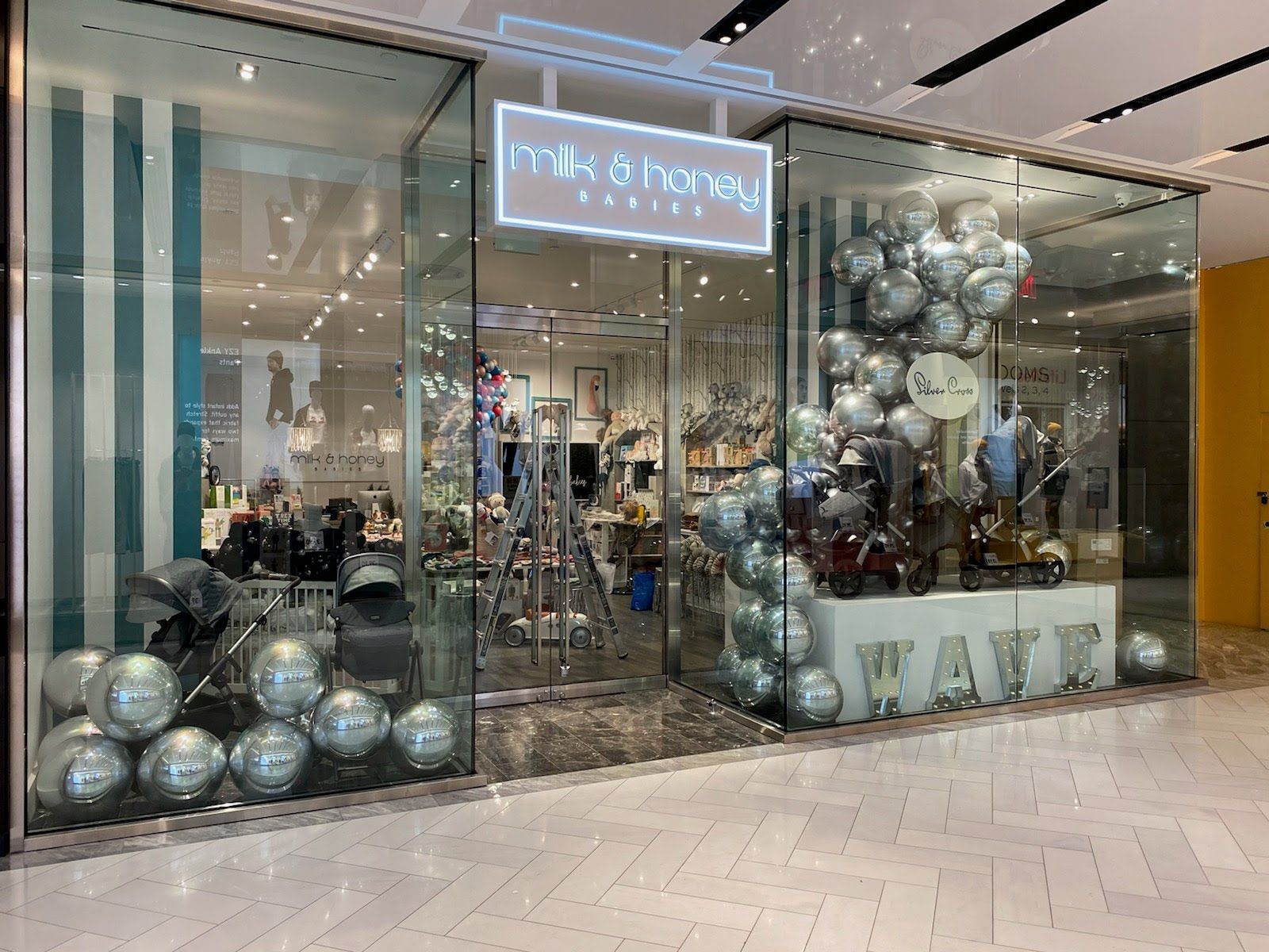 A store with a lot of balloons in front of it.