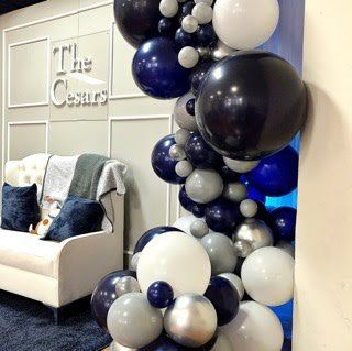 A room filled with red balloons and a sign that says `` you be ''.