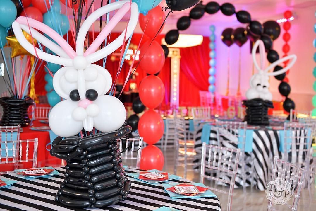 A table decorated with balloons and a bunny made out of balloons.