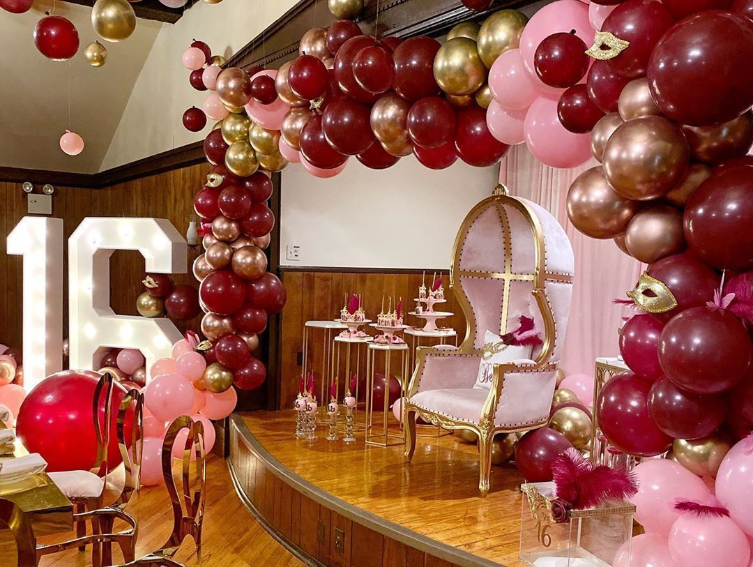 A room decorated with balloons for a birthday party.