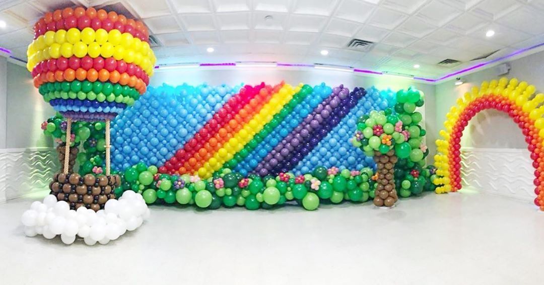 A room decorated with balloons and a hot air balloon.