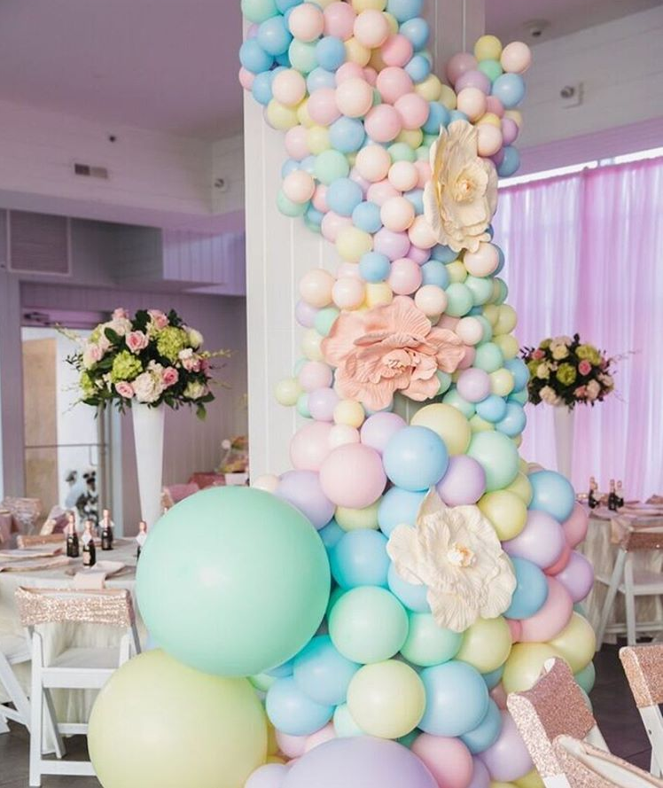 A room filled with lots of balloons and flowers