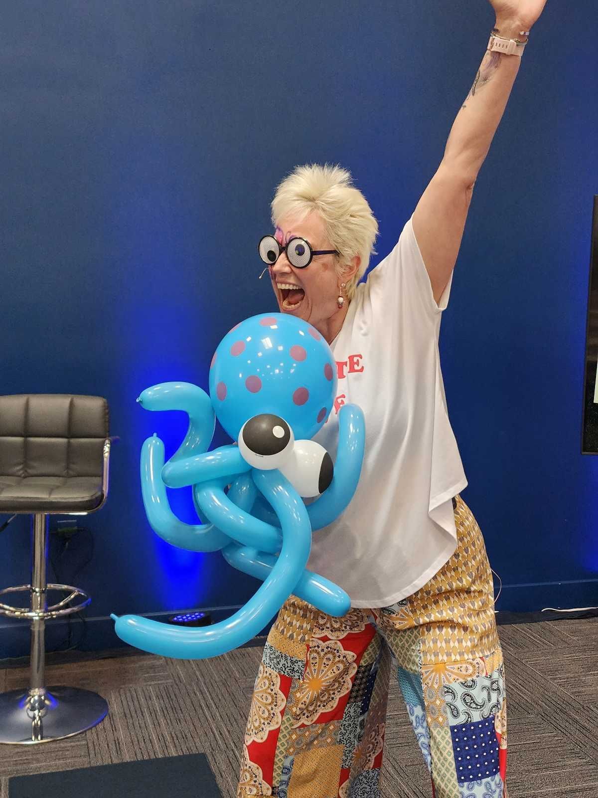 image of julie with an octopus balloon and big eye glasses showing her fun side