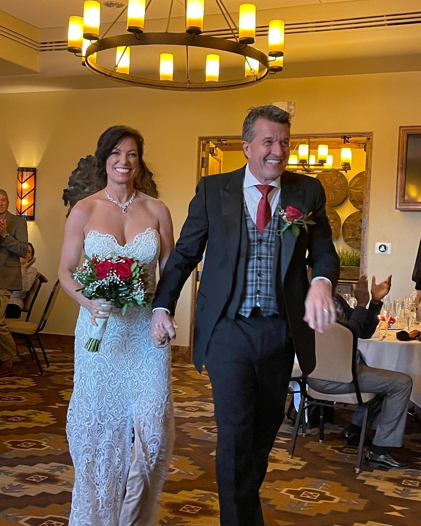 newly married couple walk into a room