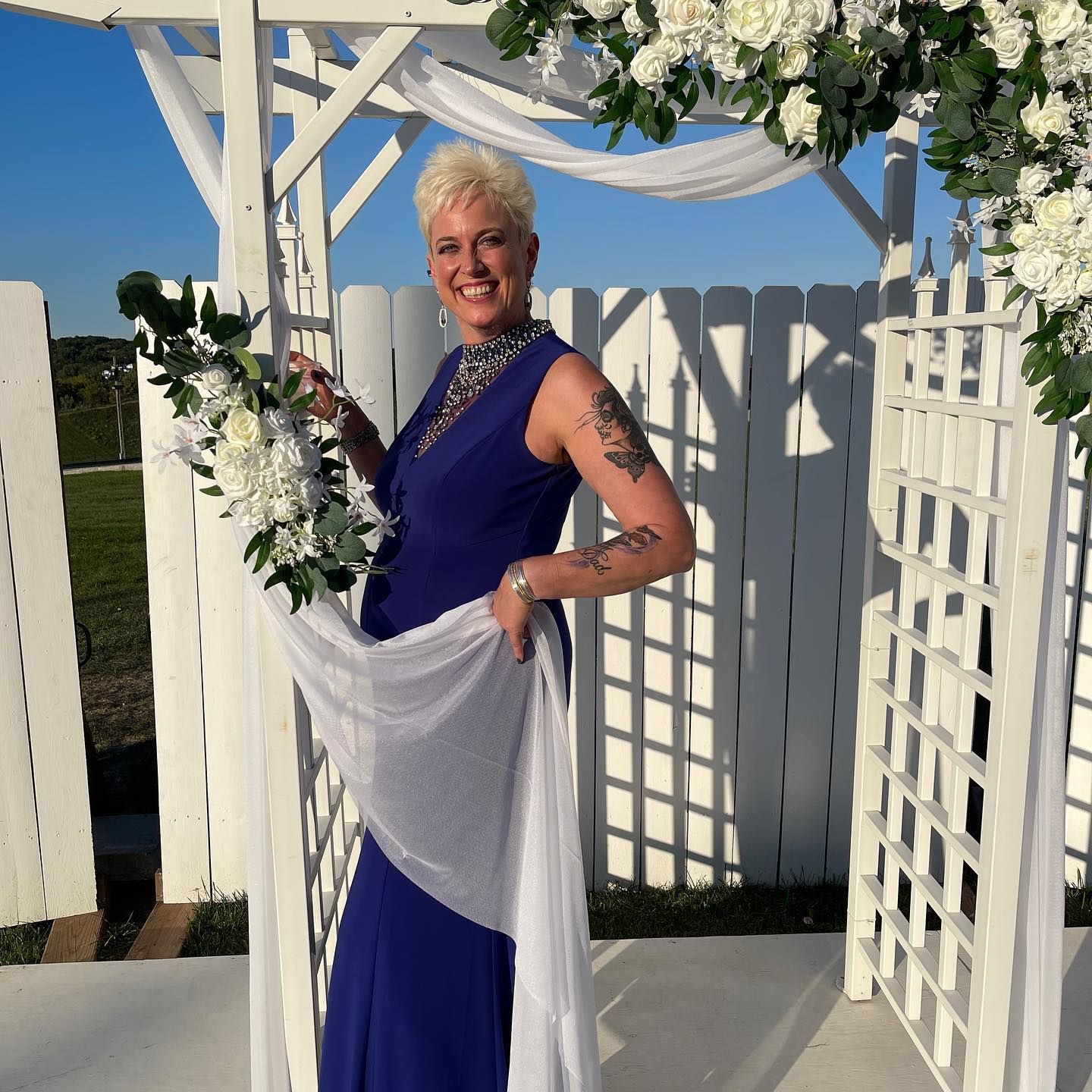 Julie stands with flowers before a wedding begins