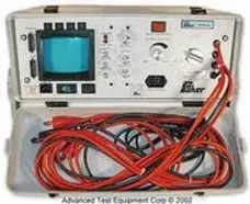 A portable oscilloscope with red wires in a case.