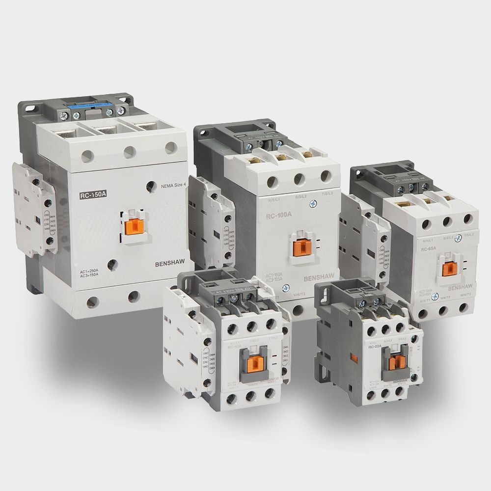 A group of electrical contactors of different sizes are sitting next to each other on a white surface.
