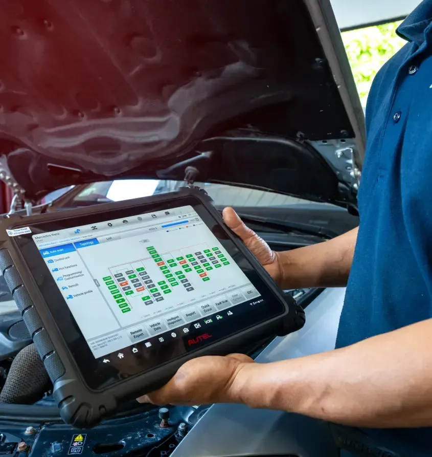 Man Performing Diagnostics on Vehicle | Import AutoWerks