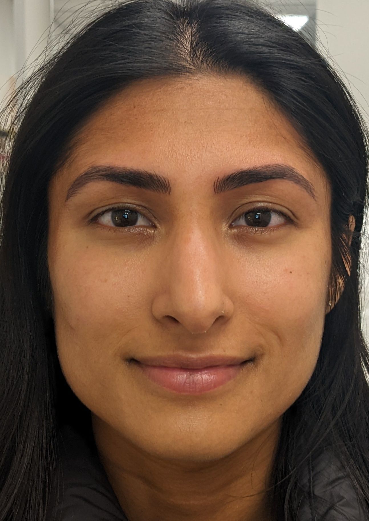 A close up of a woman 's face without makeup.