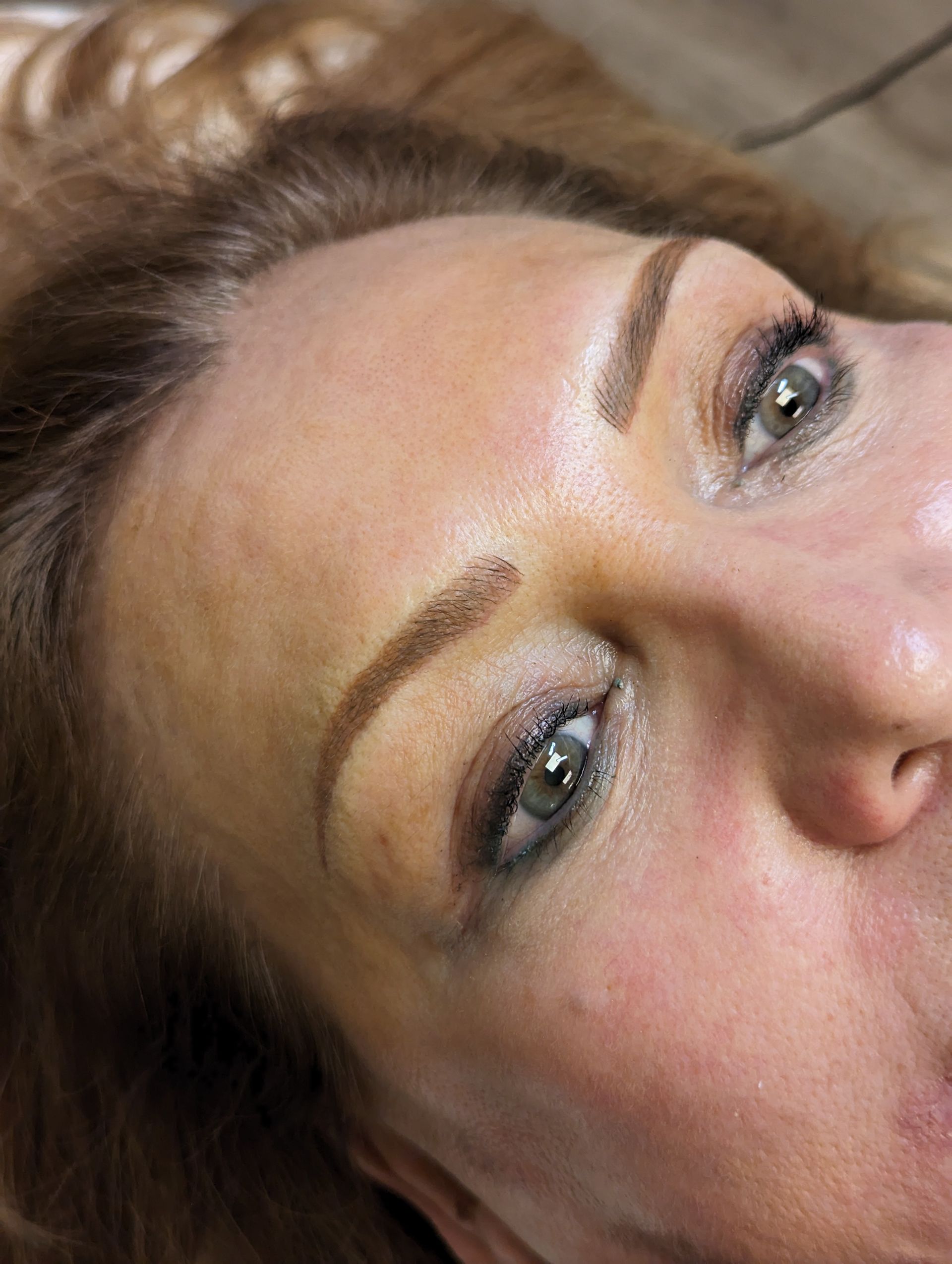 A close up of a woman 's face with makeup on.