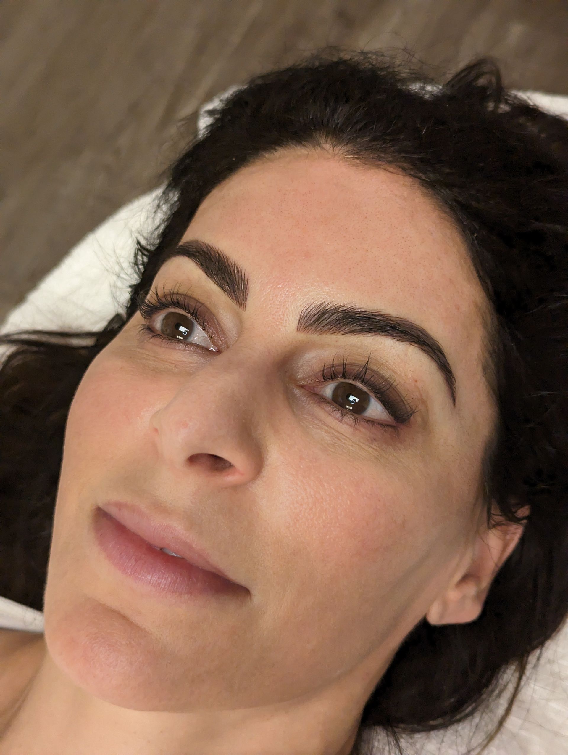 A close up of a woman 's face with a towel around her neck.