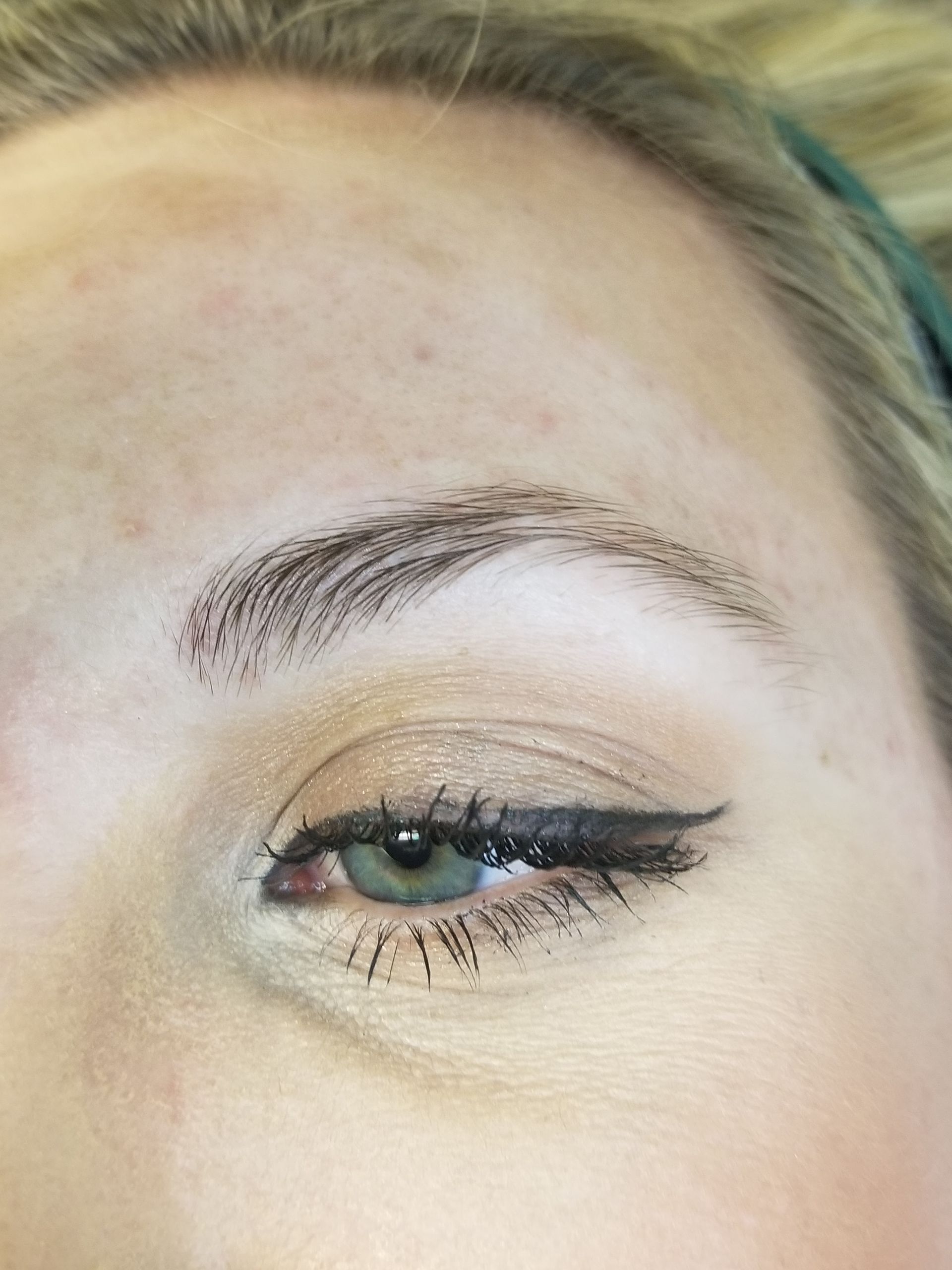 A close up of a woman 's eye with makeup on.