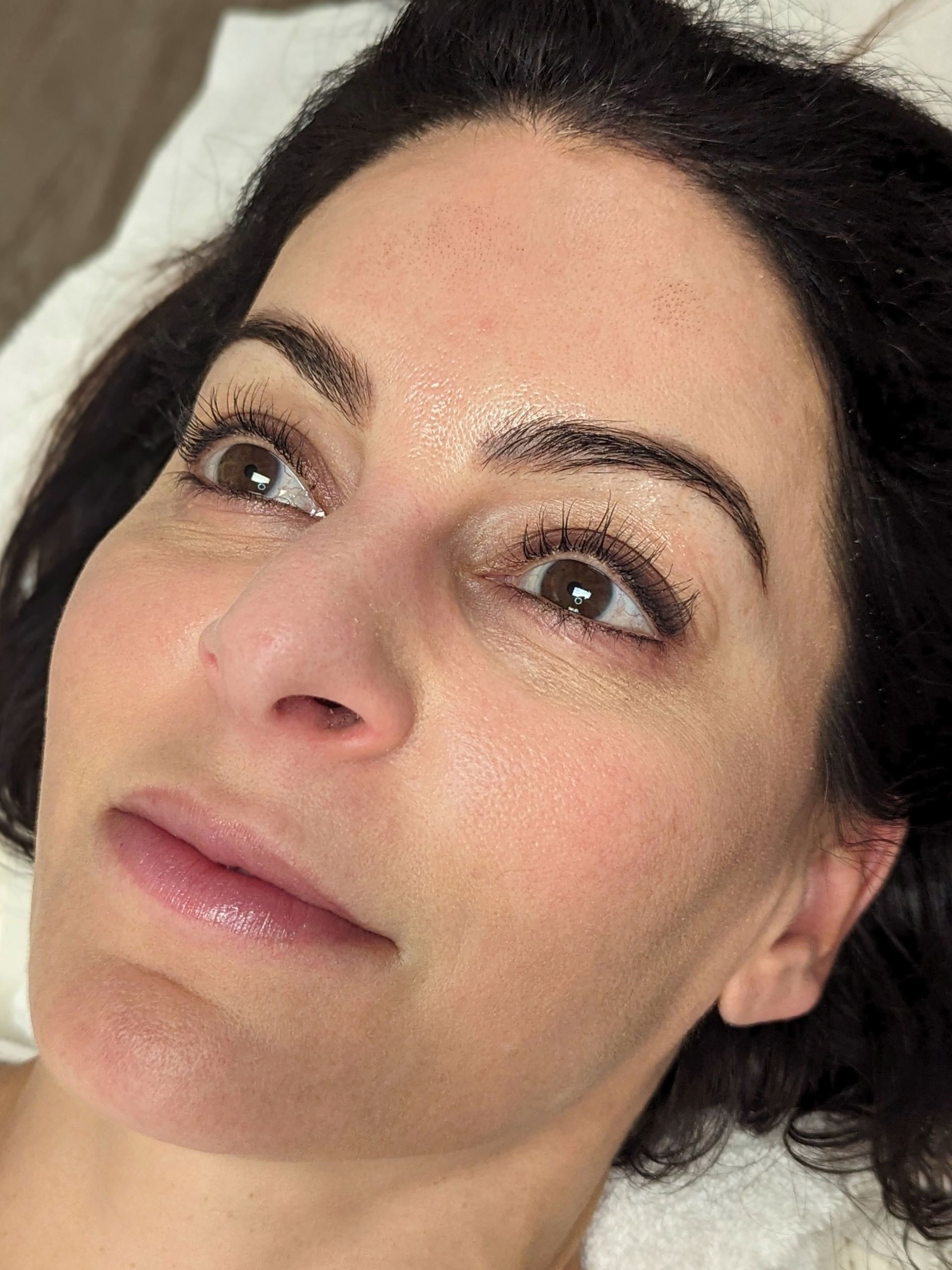 A close up of a woman 's face with her eyes closed